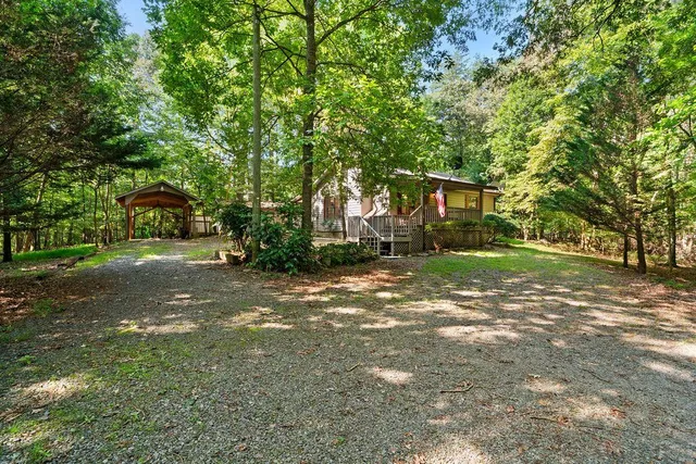 a view of a house with yard and tree s