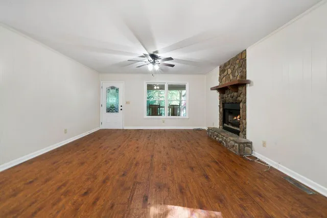 wooden floor in an empty room with a window