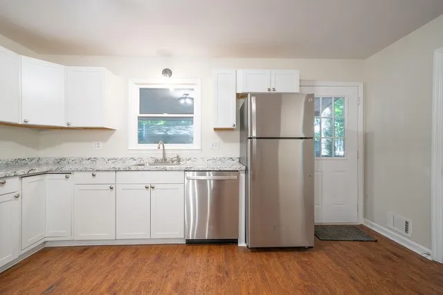 a white refrigerator freezer sitting inside of a kitchen