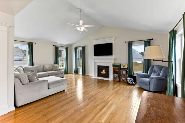 a living room with furniture a fireplace and a flat screen tv