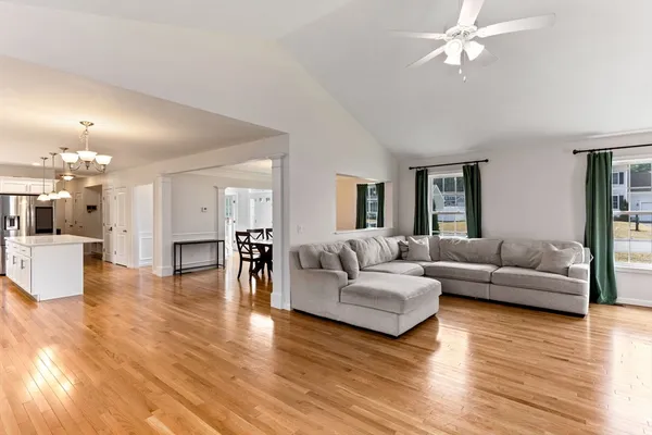 a living room with furniture and a wooden floor