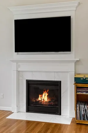 a living room with a fireplace and a flat screen tv