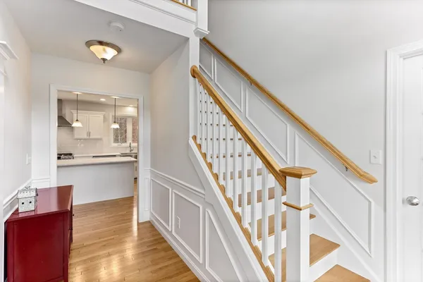 a view of entryway and hall with wooden floor