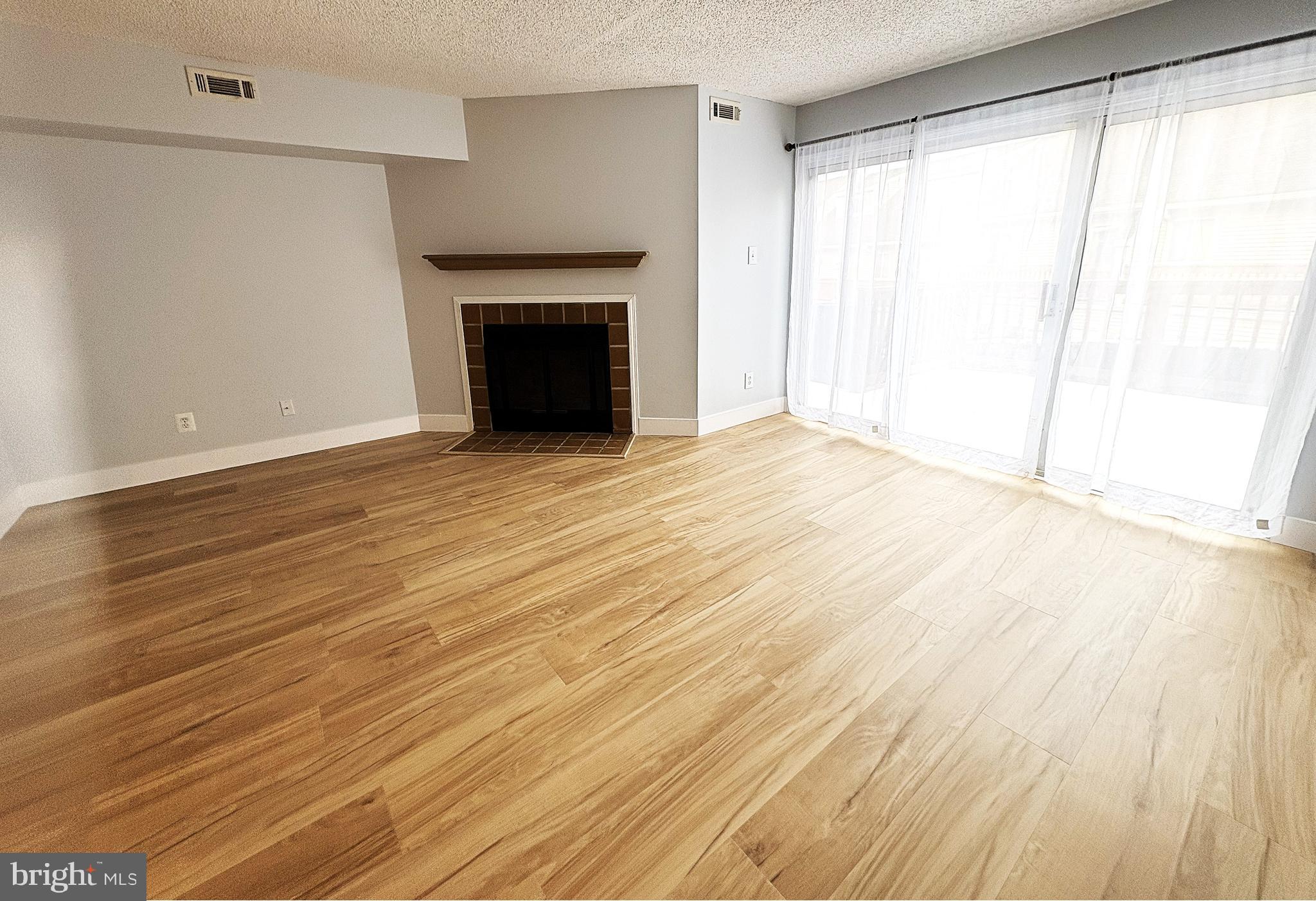 306 Paddock Drive Chesterbrook, PA 19087 - Photo 6 of 21 a view of empty room with wooden floor and fireplace