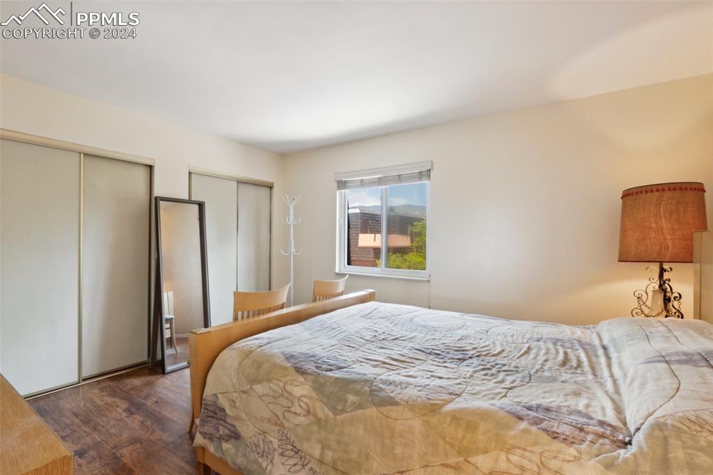 2927 Mesa Road, Unit C Colorado Springs, CO 80904 - Photo 18 of 34 a bedroom with a bed and a lamp