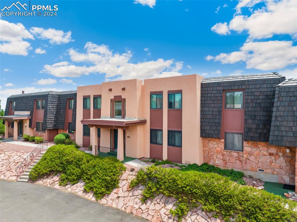 2927 Mesa Road, Unit C Colorado Springs, CO 80904 - Photo 2 of 34 a view of a brick building next to a yard