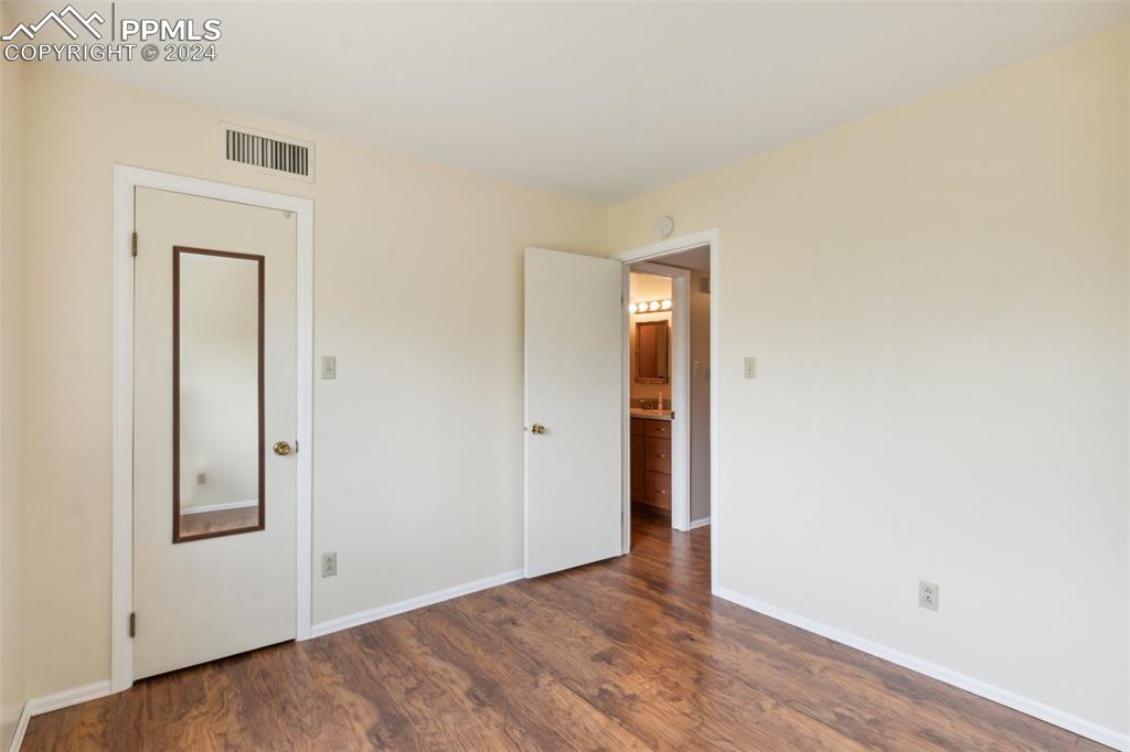 2927 Mesa Road, Unit C Colorado Springs, CO 80904 - Photo 24 of 34 an empty room with wooden floor and closet