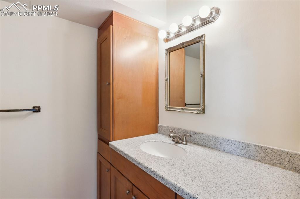 2927 Mesa Road, Unit C Colorado Springs, CO 80904 - Photo 26 of 34 a bathroom with a granite countertop sink and a mirror
