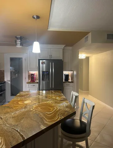 a room with dining table and chandelier