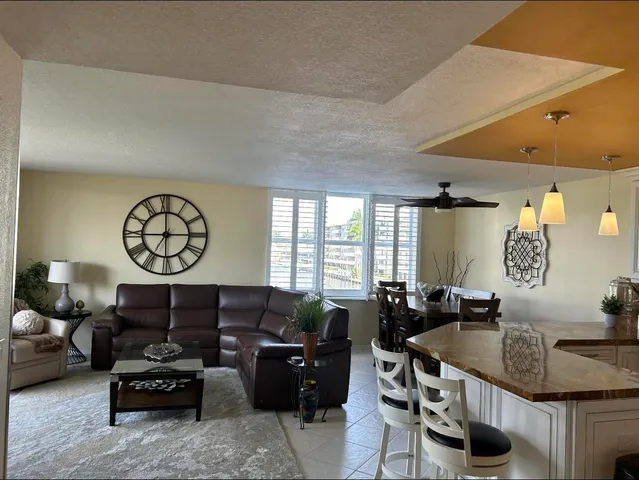 a living room with furniture a table and a window