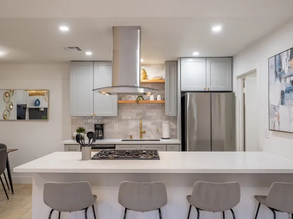 a kitchen with stainless steel appliances kitchen island granite countertop a sink and cabinets