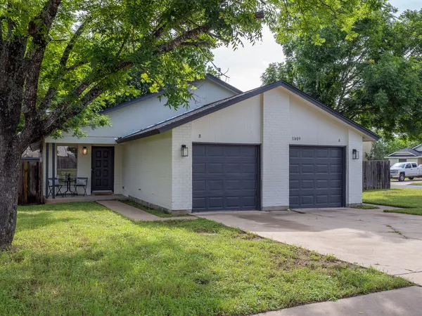 a view of a house with a yard and garage