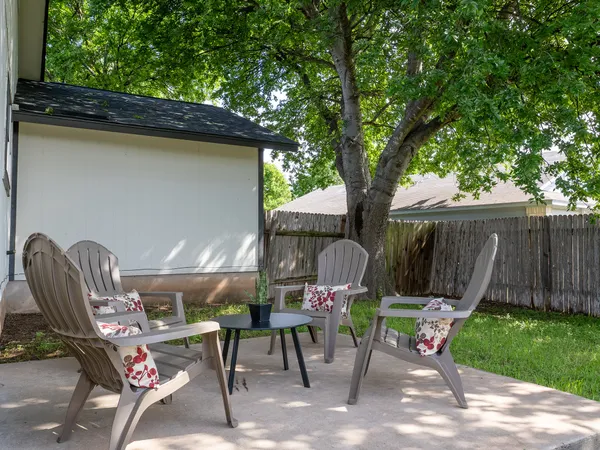 a view of a chairs and table in the patio
