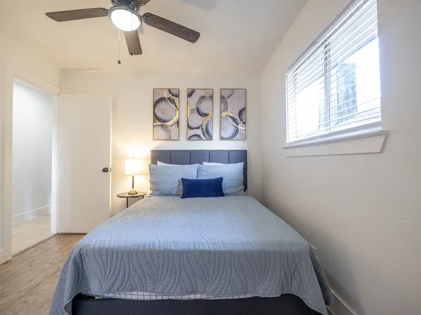 a bedroom with a bed and a window