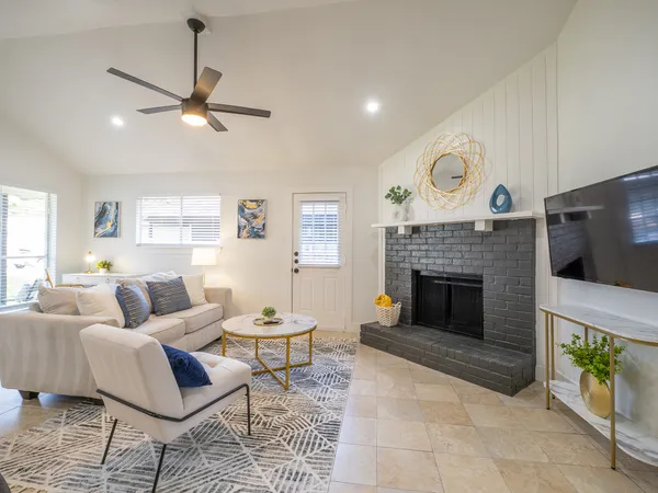 a living room with furniture and a fireplace