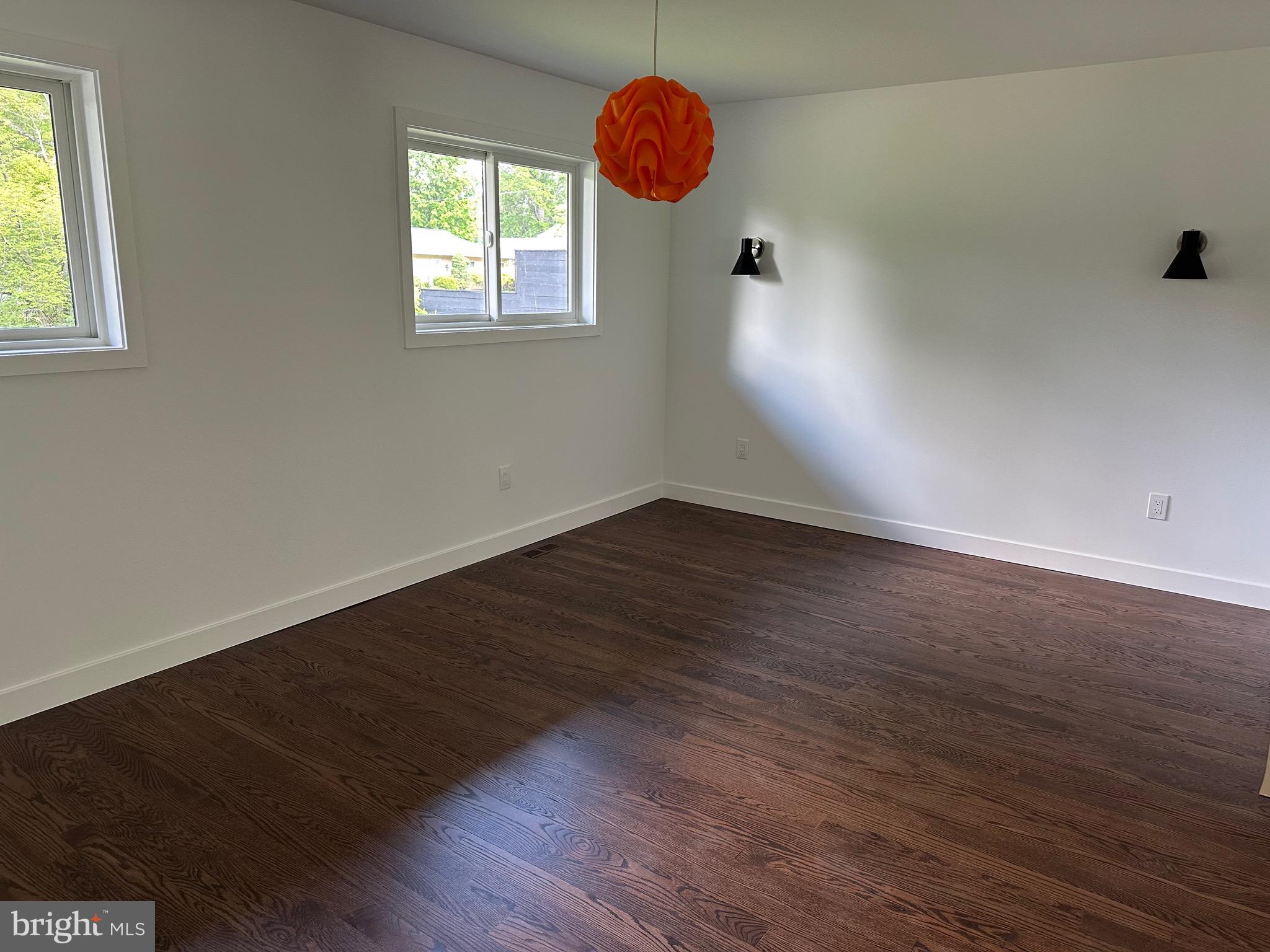 713 Woodfield Road Villanova, PA 19085 - Photo 12 of 36 an empty room with wooden floor and windows
