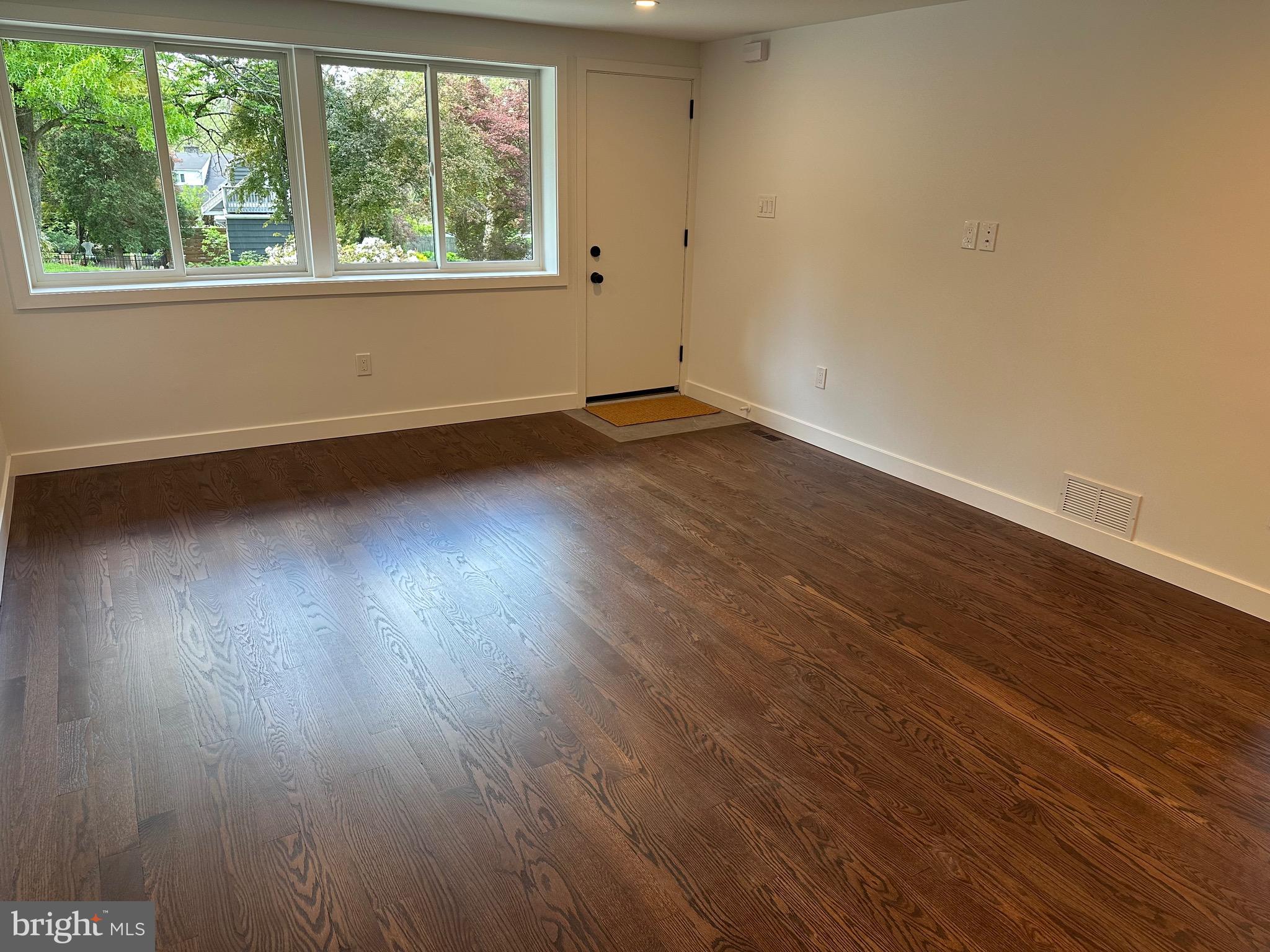 713 Woodfield Road Villanova, PA 19085 - Photo 13 of 36 an empty room with wooden floor and windows