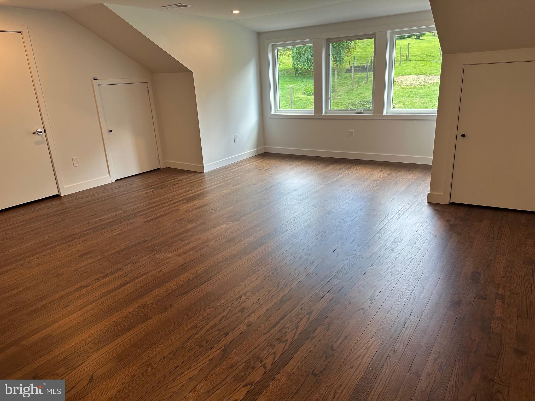 713 Woodfield Road Villanova, PA 19085 - Photo 14 of 36 an empty room with wooden floor and windows