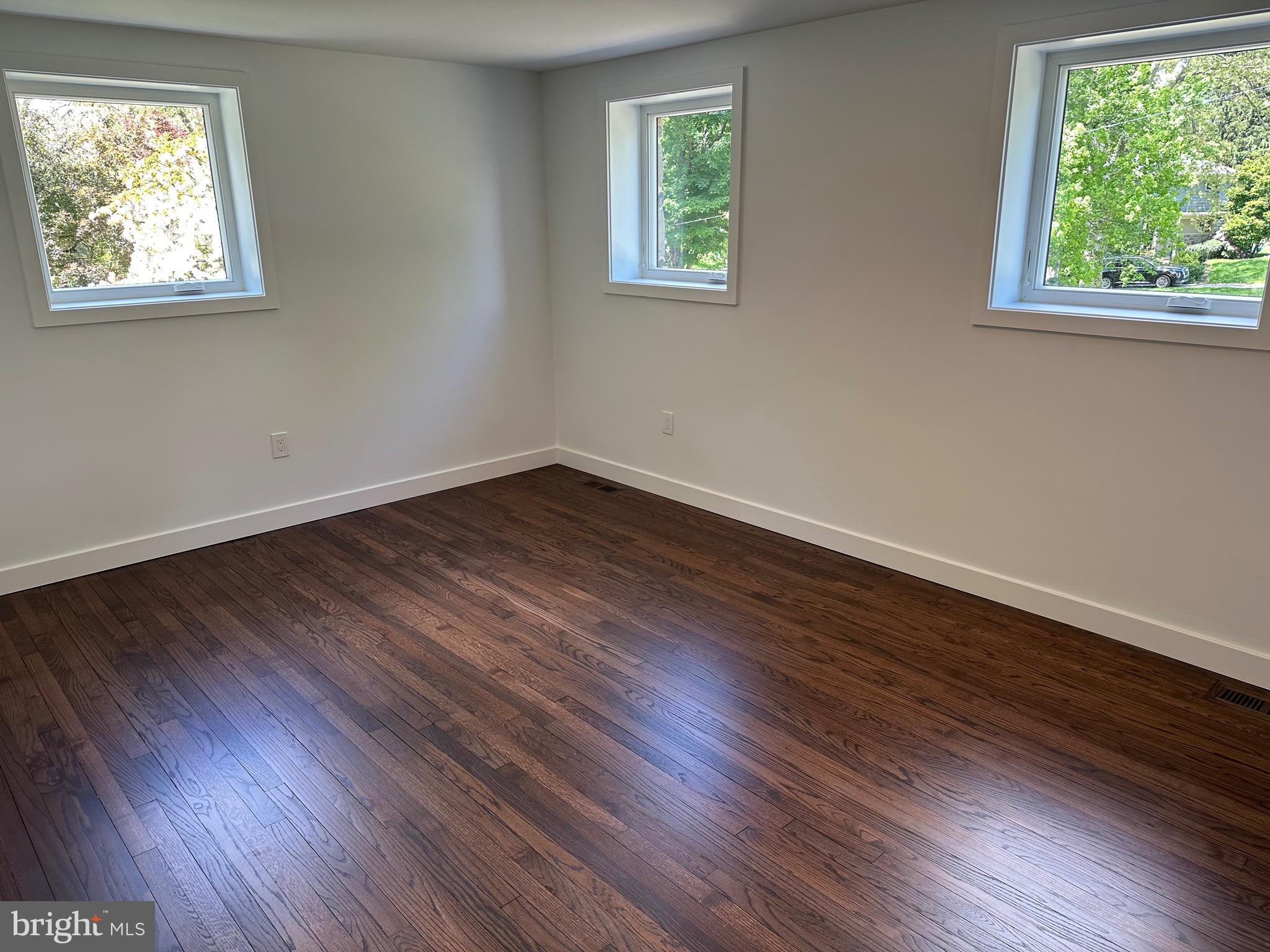 713 Woodfield Road Villanova, PA 19085 - Photo 26 of 36 a view of an empty room with wooden floor and a window