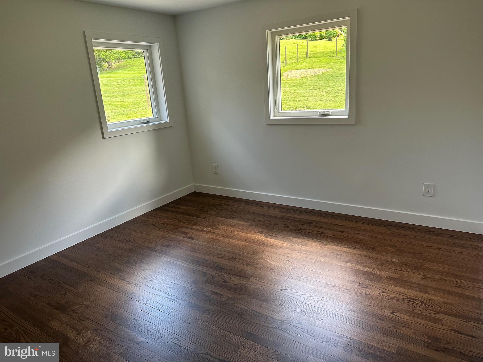 713 Woodfield Road Villanova, PA 19085 - Photo 28 of 36 a view of an empty room with wooden floor and a window