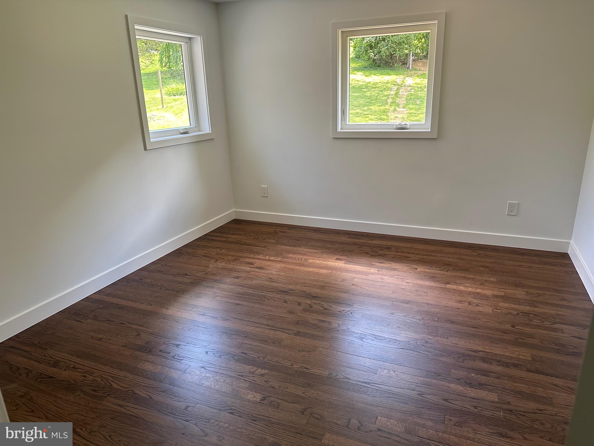 713 Woodfield Road Villanova, PA 19085 - Photo 29 of 36 an empty room with wooden floor and windows