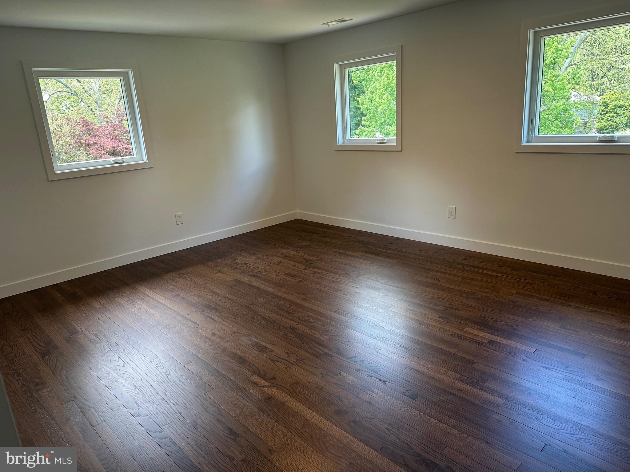 713 Woodfield Road Villanova, PA 19085 - Photo 30 of 36 an empty room with wooden floor and windows
