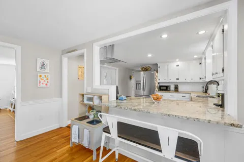 a kitchen with a sink cabinets and wooden floor
