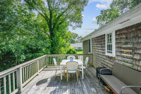 882 West Yarmouth Road Yarmouth Port, MA 02675 - Photo 32 of 36 a view of a deck with table and chairs and wooden floor