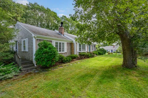 a view of an house with backyard space and garden