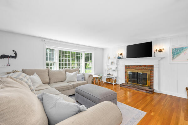 882 West Yarmouth Road Yarmouth Port, MA 02675 - Photo 8 of 36 a living room with furniture a fireplace and a flat screen tv