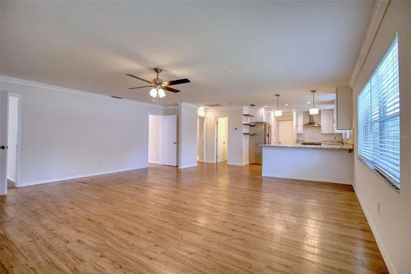 a view of an empty room with a kitchen