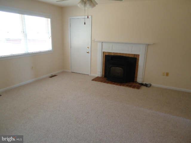 6838 Warfield Road Gaithersburg, MD 20882 - Photo 9 of 17 an empty room with a fireplace