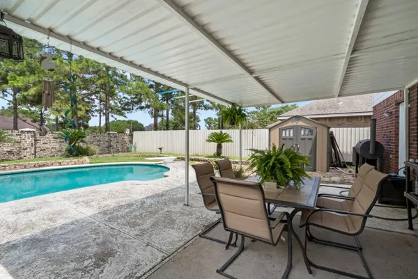 a dining room with furniture and a floor to ceiling window