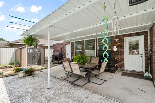a patio with a yard table and chairs