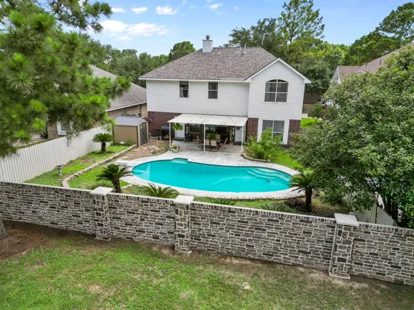 a view of a patio with table and chairs and potted plants