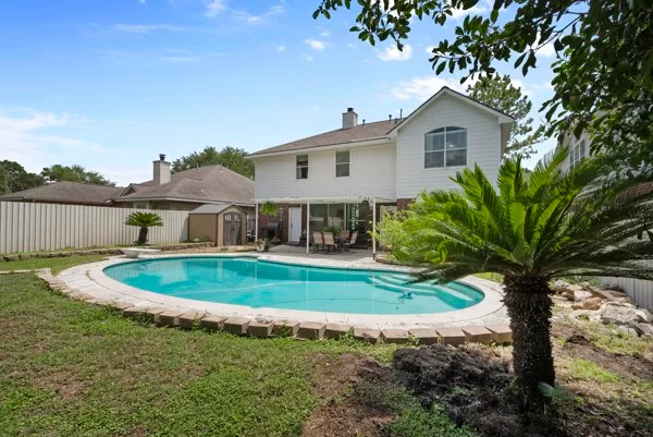 a view of house with yard and outdoor seating