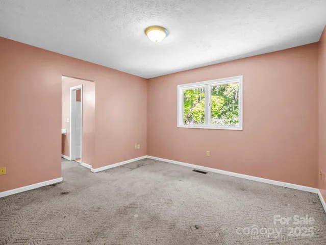 a view of empty room with sliding windows