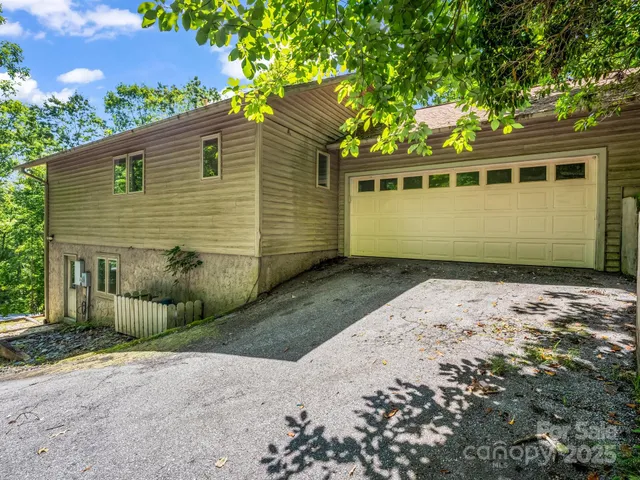 a house with a big yard and large trees