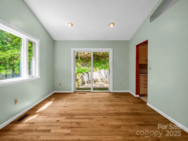 a large kitchen with stainless steel appliances granite countertop a large counter top a stove and a sink