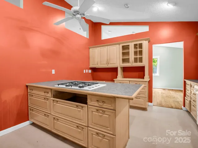 a kitchen with stainless steel appliances granite countertop a sink and a stove