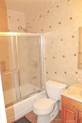 a white toilet sitting next to a bathroom sink