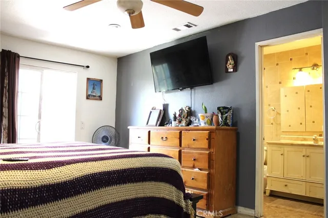 a bedroom with a bed and flat screen tv