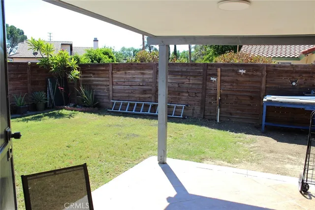 a view of a backyard with sitting area
