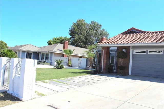 a front view of a house with a garden