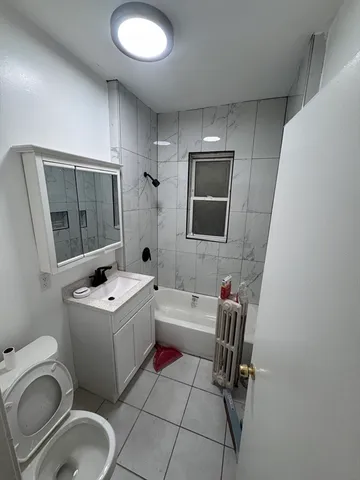 a bathroom with a sink toilet tub and mirror