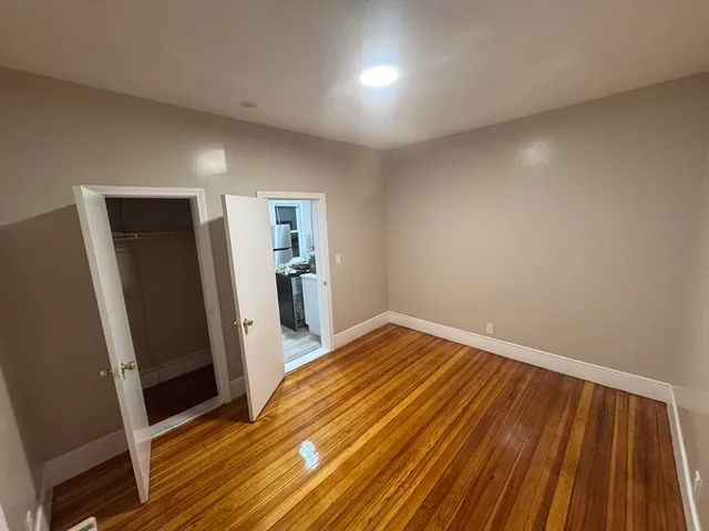 a view of a room with wooden floor and a sink