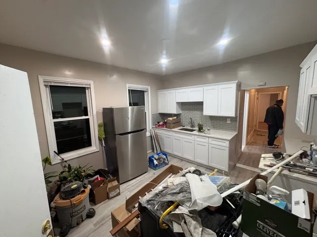 a kitchen with a sink appliances and cabinets