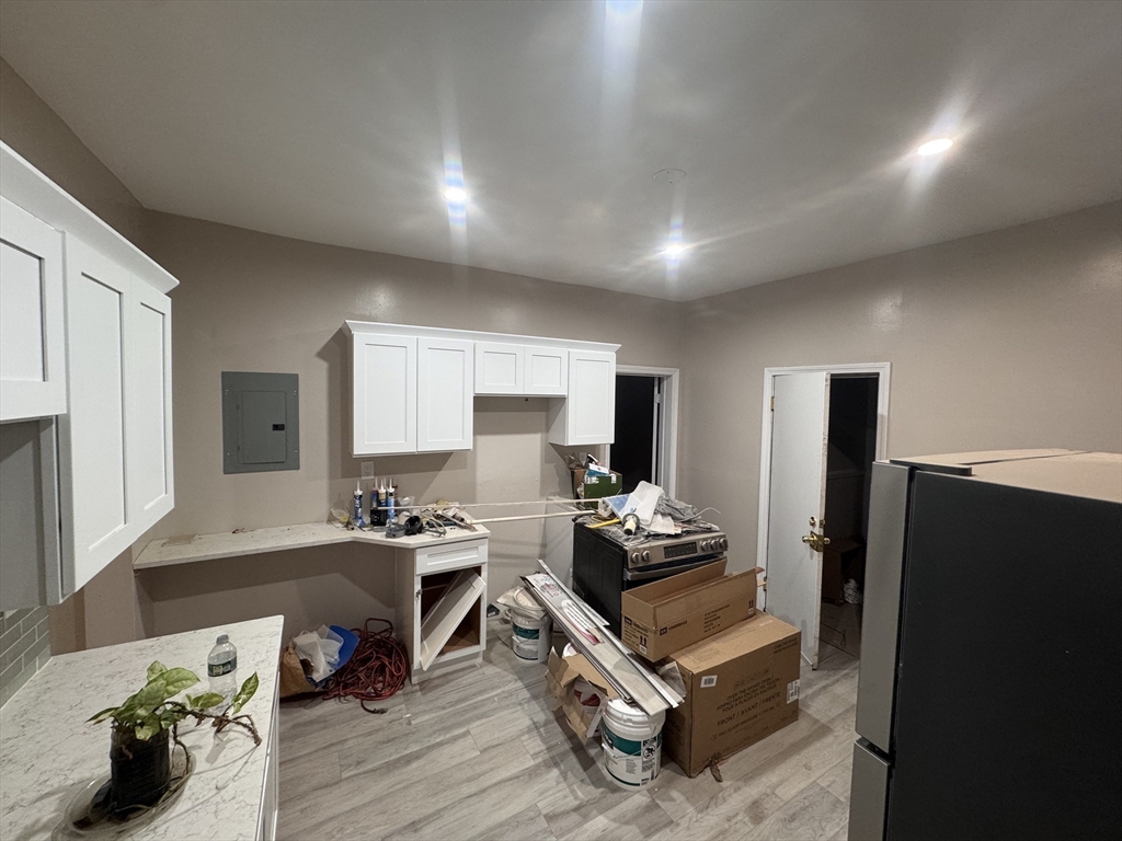 42 Lucerne Street, Unit 3 Boston, MA 02124 - Photo 4 of 8 a living room with furniture and a flat screen tv