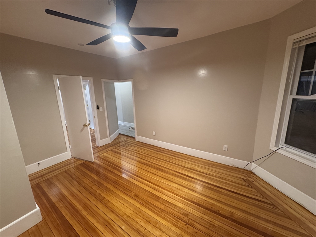 42 Lucerne Street, Unit 3 Boston, MA 02124 - Photo 6 of 8 a view of an empty room with wooden floor