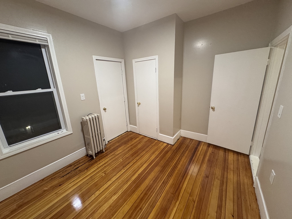 42 Lucerne Street, Unit 3 Boston, MA 02124 - Photo 7 of 8 a view of a room with wooden floor and staircase